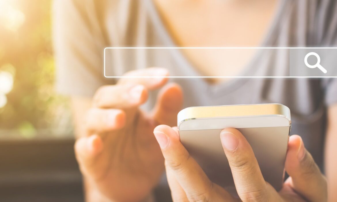 what do seo experts do using a smartphone with a search bar graphic on the screen.