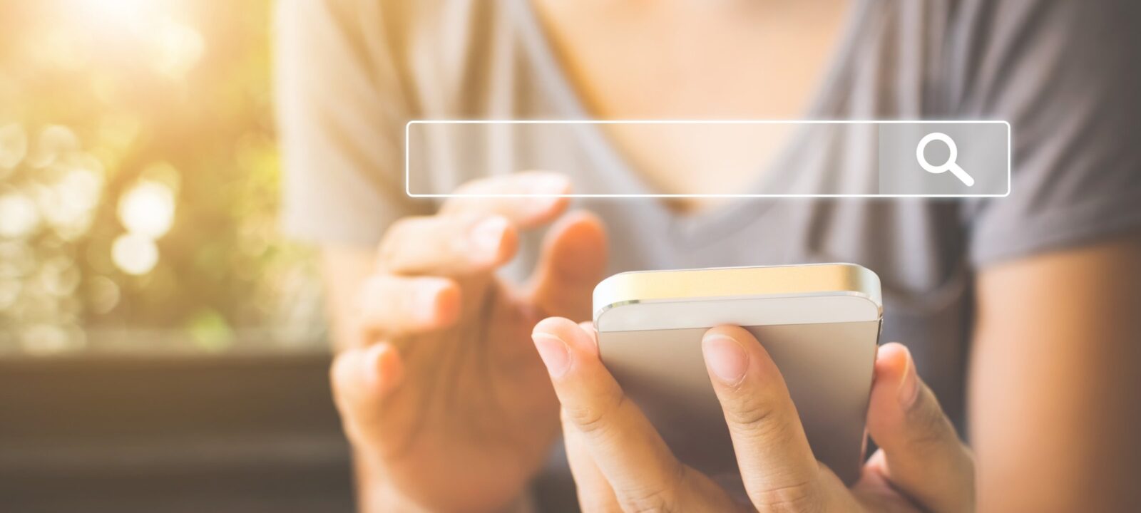 what do seo experts do using a smartphone with a search bar graphic on the screen.